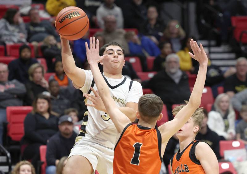 Sycamore's Diego Garcia passes over DeKalb's Jackson Kees during the First National Challenge Friday, Jan. 27, 2023, at The Convocation Center on the campus of Northern Illinois University in DeKalb.