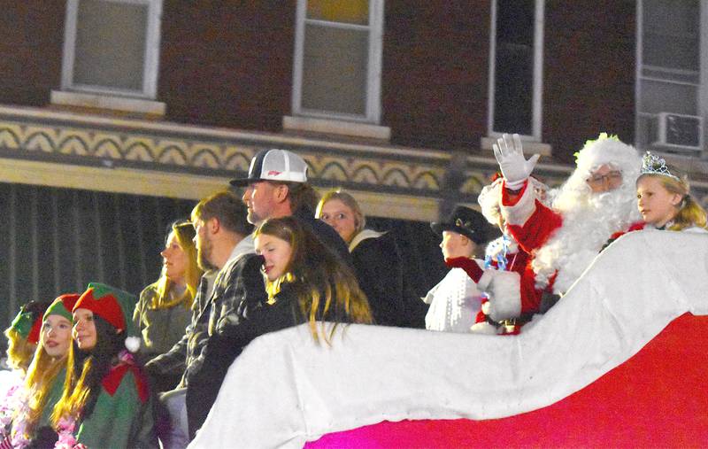 Santa waves to the crowd as he rides in his sleigh in the lighted parade at Morrison's Christmas Walk on Saturday, Dec. 7, 2024.