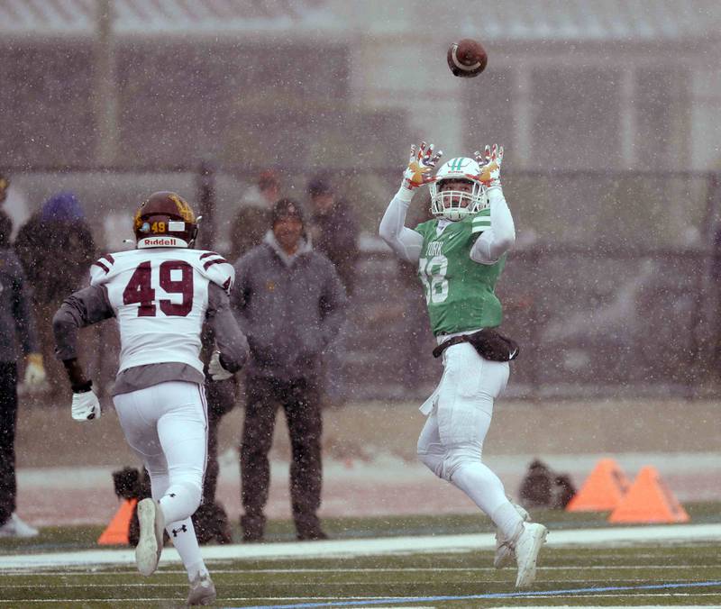 York’s Anthony Mancini Jr. (38) hauls in a long pass over Loyola's Emmanuel Ofosu (49) during the IHSA Class 8A semifinal football game Saturday November 19, 2022 in Elmhurst.
