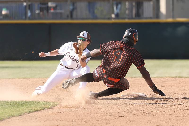 Joliet Catholic’s Lucas Simulick fields a throw to tag out Leo’s Mitchell Hall in the Class 2A sectional semifinal on Thursday, May 25, 2023, in Joliet.