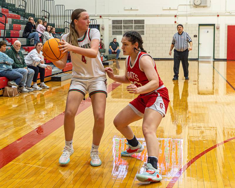 Emma Jereb (4) of LaSalle-Peru looks for pass as Mary Stisser (23) of Ottawa guards at hip on Wednesday, December 17, 2025 at Sellet Gymnasium in LaSalle.