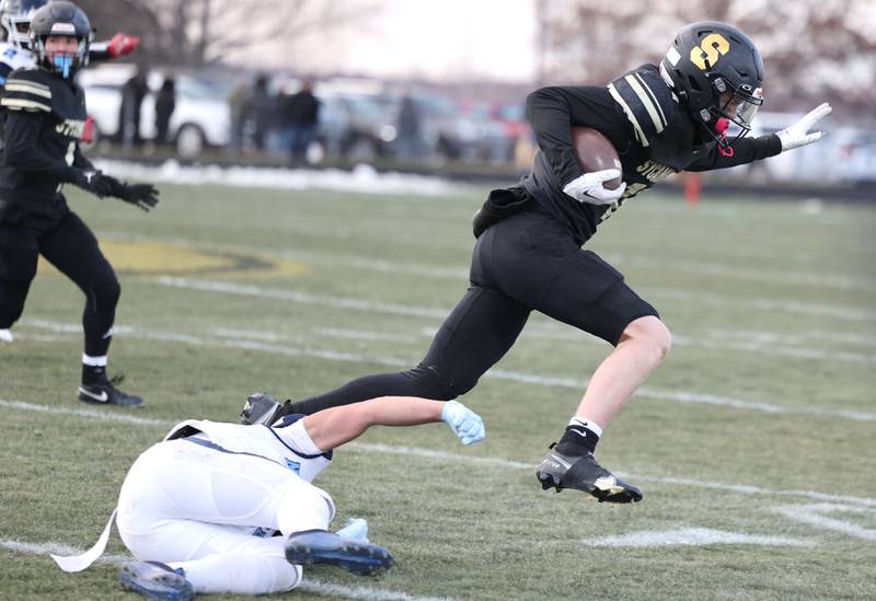 Sycamore's Burke Gautcher breaks a tackle by Nazareth's Ethan Enriquez late in the fourth quarter Saturday, Nov. 18, 2022, during their state semifinal game at Sycamore High School.