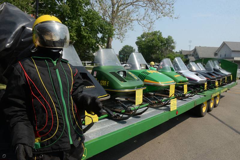 A mannequin, dressed in a snowmobile suit, stands by Dan Dykstra's nine vintage snowmobiles that he had on display at the Milledgeville car show on Sunday, June 4. The snowmobiles, made from 1974-1984, didn't mind the 80-degree temperatures, but the mannequin seemed to be a bit on the sweaty side.