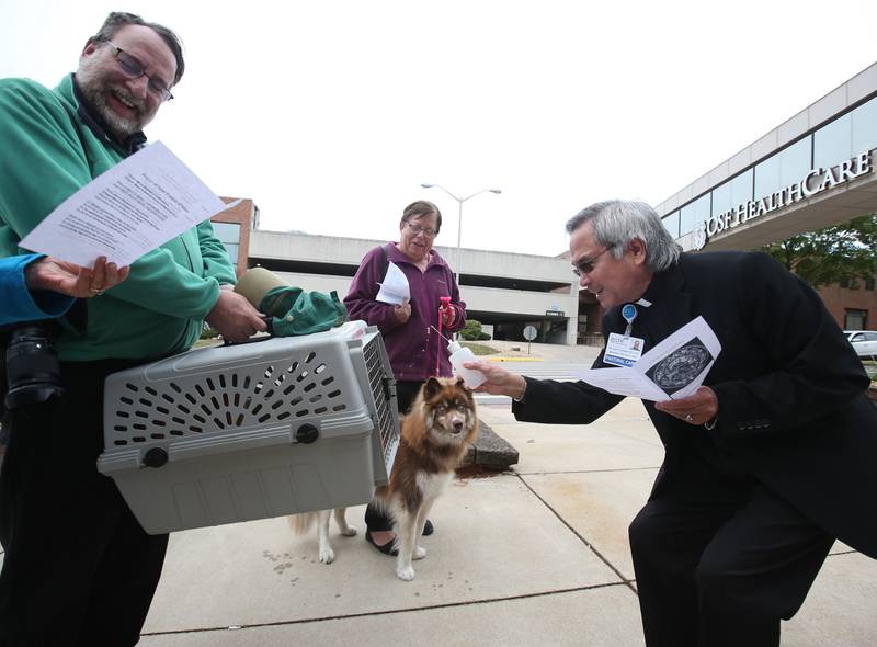 Father Nick Husain blessses a cat named Butterscotch owned by Gary Talski of Spring Valley (left) and a dog Moxie owned by Kathy Wujek of Peru (center) during the OSF Healthcare Blessing of the Animals on Friday, Oct. 4, 2024 at OSF Saint Elizabeth Medical Center in Peru. The blessing is a celebration of St. Francis of Assisi, who was known for his live of animals.