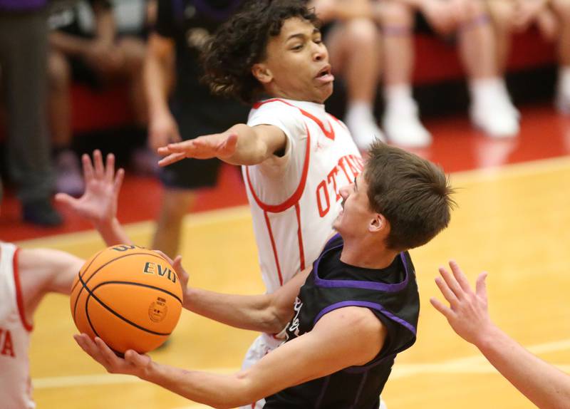 Plano's Vinny Cesario eyes the hoop as Ottawa's Hezekiah Joachim defends during the Dean Riley Shootin' The Rock Thanksgiving Tournament on Tuesday, Nov. 26, 2024 in Kingman Gym at Ottawa High School.