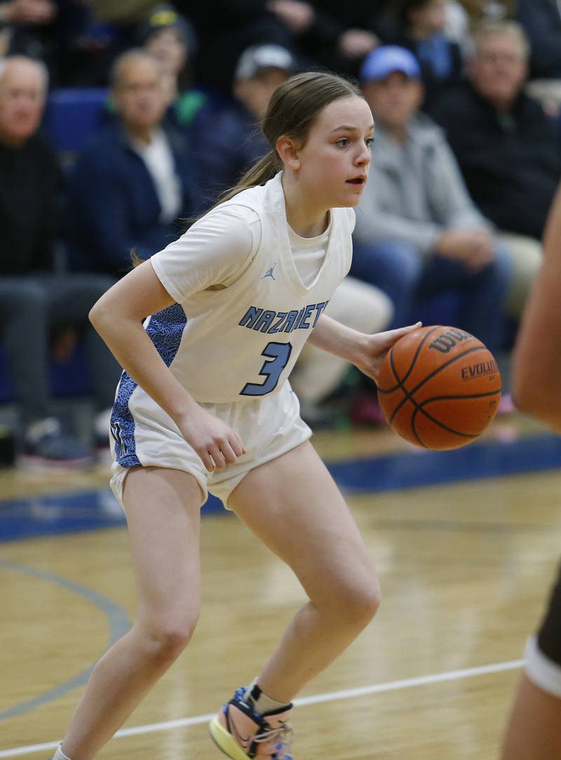 Nazareth's Lyla Shelton (3) handles the ball during the girls varsity basketball game between Carmel High School and Nazareth Academy on Wednesday, Dec. 7, 2022 in LaGrange, IL.