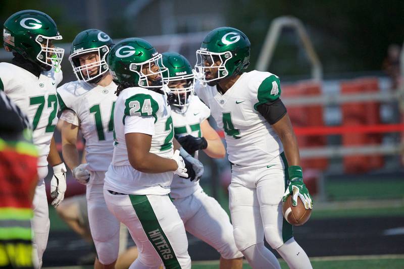 Glenbard West's Jamarcus Kelly (4) celebrates with teammates against Batavia on Friday, Aug.29,2025 in Batavia.