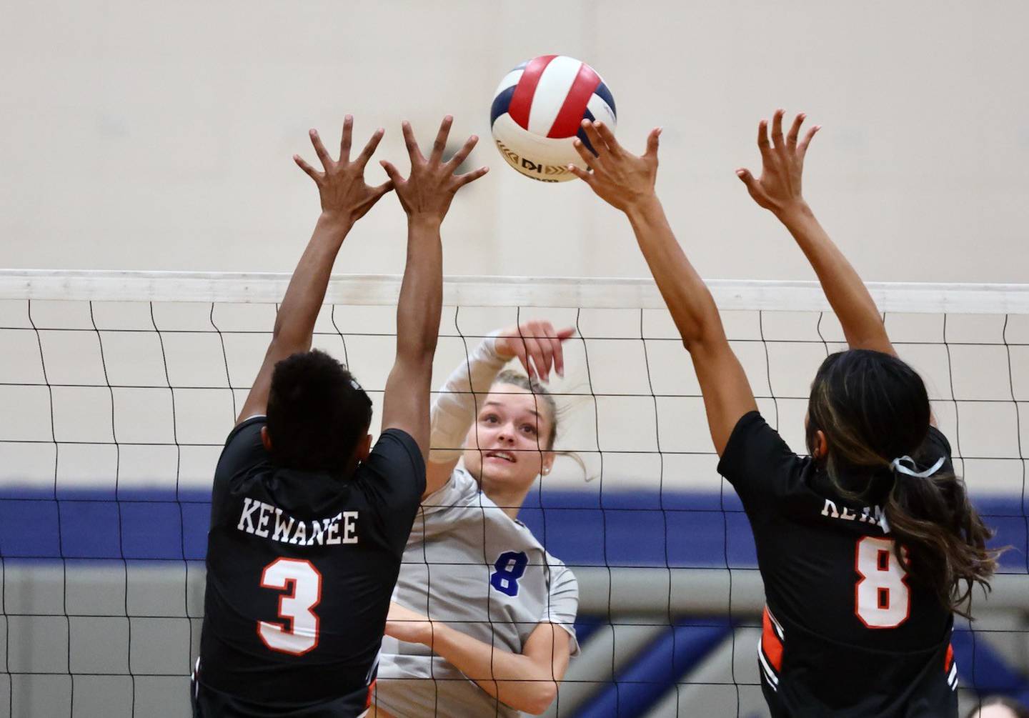 Princeton's Keighley Davis takes a hit between Kewanee's Tejhiana Amos (3) and Aaliyah Duarte (8) Tuesday night at Prouty Gym. The Tigresses won 25-8, 25-22.