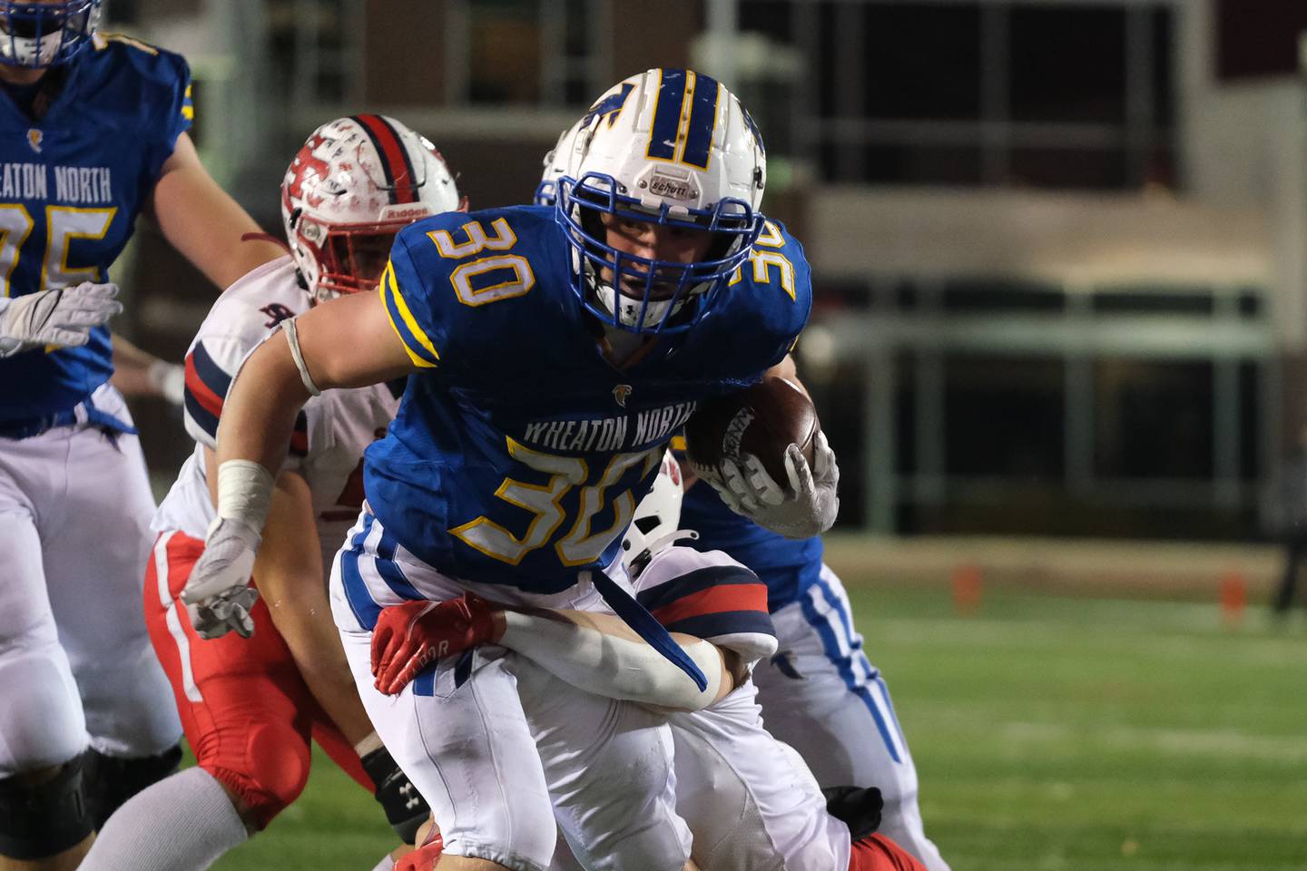 Wheaton Norths Luke Beedle powers through the front line against St. Rita in the Class 7A state championship at NIU Huskie Stadium. Saturday, Nov. 27, 2021 in Dekalb.