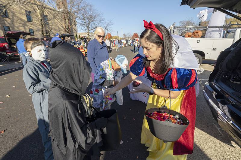 Diana Merdian, representing the Regional Office of Education, hands out candy Wednesday in Sterling. The Sterling Police Department expected 400-500 kids to pass through the trunk or treat.