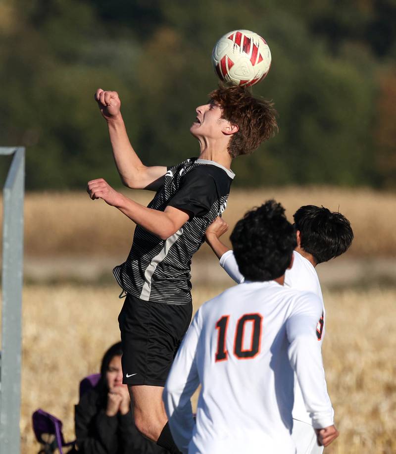 Kaneland's Josh Schimmel heads the ball over DeKalb's Joaquin Medina-Benitez during their game Thursday, Oct. 17, 2024, at Kaneland High School in Maple Park.