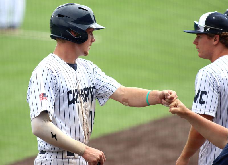 Cary-Grove’s Jacob Duvall is greeted after scoring against Triad in IHSA Class 3A Third Place Game baseball action at Slammer Stadium in Joliet on Saturday, June 14, 2025.