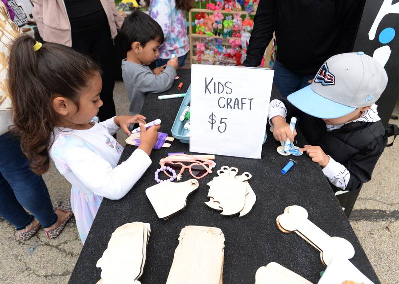 Zaid and Arya Ali of Downers Grove along with Oakley Glisson of Woodridge enjoy coloring while attending the Downers Grove Farmers Market Saturday May 13, 2023.