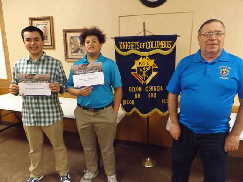 Dixon Knights of Columbus Grand Knight Mike DeSchepper (right) presented K.C. Catholic Citizenship Essay Contest awards Feb. 3 to Mason Stover (left) and Maddox Devine of St. Mary’s Junior High School.