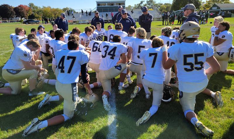 Marquette head coach Tom Jobst and his staff address the Crusaders after Saturday's 52-0 win over Walther Christian in Melrose Park on Oct. 8, 2022.