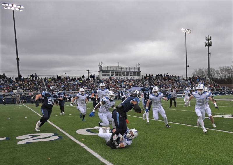 St. Francis’ Tanner Glock stops Nazareth’s Edward McClain in the IHSA Class 5A state semifinal football game in La Grange on Saturday, Nov. 23, 2024.