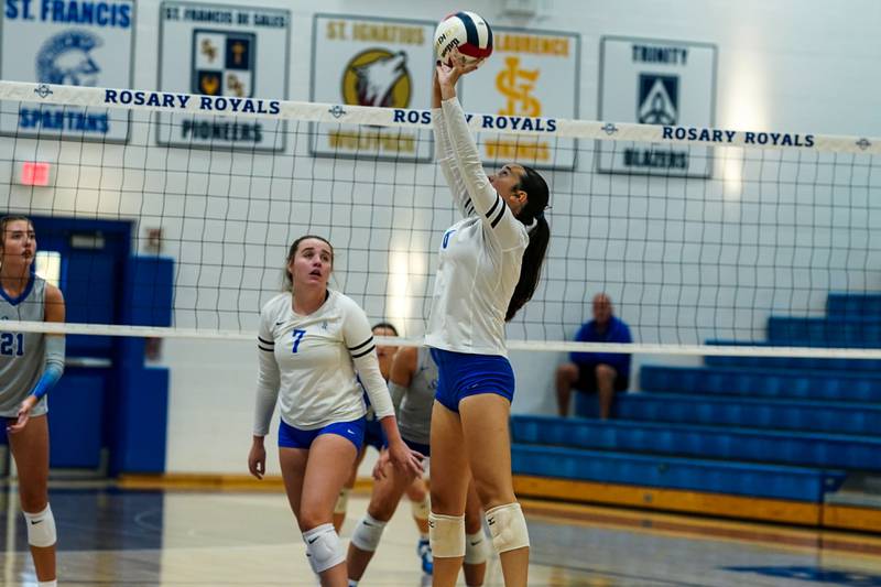 Rosary’s Evelyn Hauser (8) sets the ball against St. Charles North during a volleyball game at Rosary High School in Aurora on Monday, Aug 25, 2025.