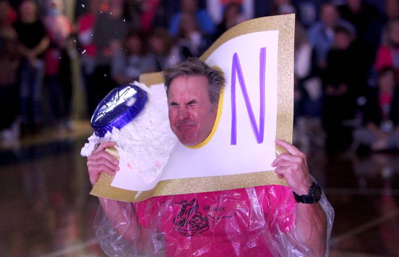 Nazareth Head Football Coach Tim Racki gets a pie thrown at his face during a homecoming pep rally at the La Grange Park school on Friday, Sept. 30, 2022.