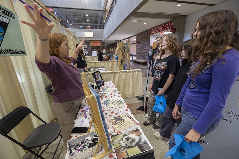 Nora Reuter of Dixon gestures while speaking to a group of eighth-graders Friday, Oct. 18, 2024 about her life and career as an artist. Reuter joined over 70 other businesses at SVCC to educate students about career choices.