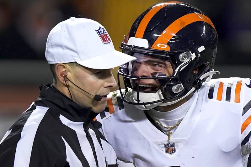 Chicago Bears quarterback Justin Fields, right, yells at referee Scott Novak after Fields was tackled hard into the ground by Minnesota Vikings defensive tackle James Lynch during the second half Monday, Dec. 20, 2021, in Chicago.