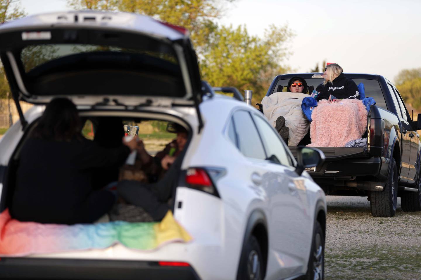 Nick Passafiume of Lake Zurich and Amber Wells of McHenry were all bundled up at McHenry Outdoor Theater when it reopened Friday April 30, 2021, as they settled into the bed of their truck waiting for the sun to drop to watch the double feature. Both said the last film they saw together at the drive-in was "The Breakfast Club" last year.
