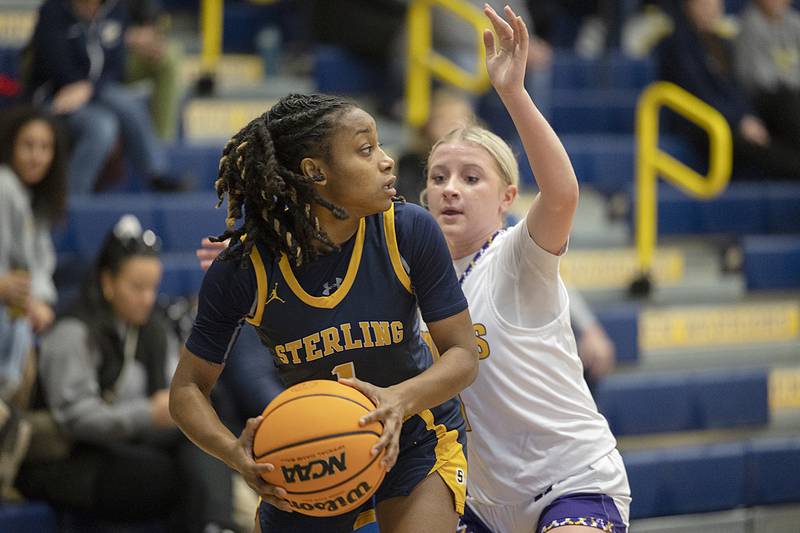 Sterling’s Taah Liberty look to pass against Hononegah’s Carly Koch Saturday, Dec. 21, 2024, during the Sterling Shootout.
