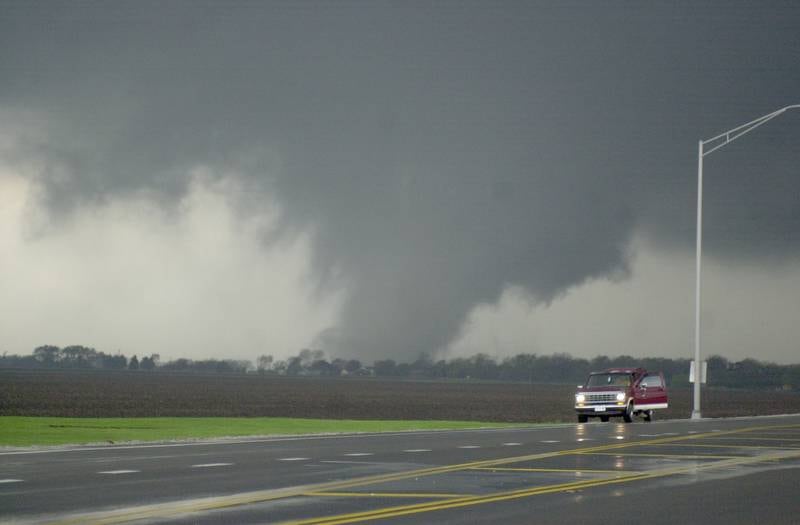A tornado moves along the Illinios River as it crosses Illinios Route 251 on Tuesday, April. 20, 2004 near Illinois Valley Community College in Oglesby. The tornado was headed straight for the Village of Utica.