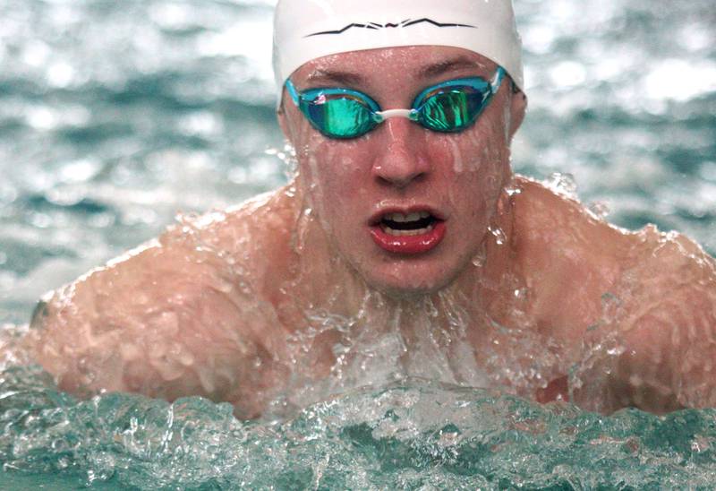 Kasparas Venslauskas of Cary-Grove co-op swims the breaststroke leg of the 200-Yard Medley Relay during the Fox Valley Conference Swimming Championships at Woodstock North High School Saturday.