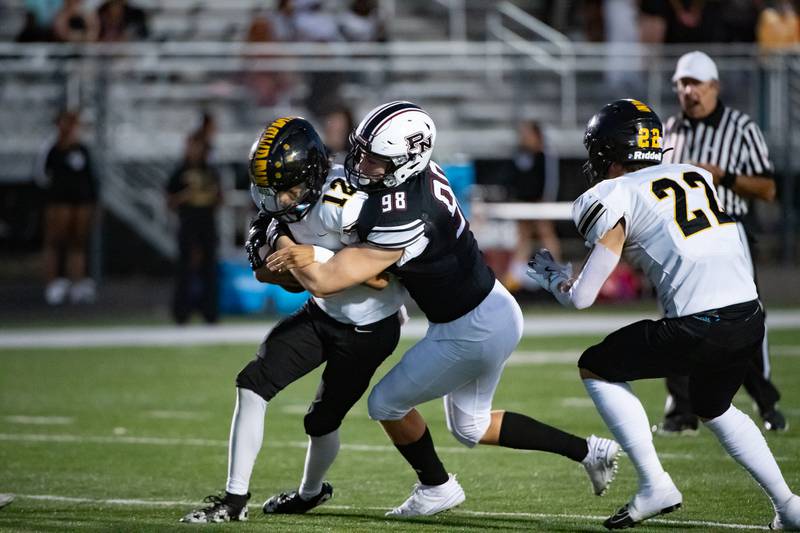Plainfield North's Jake Jimenez takes down Joliet West's Antoine Brooks during a game Friday Sept. 20, 2024 at Plainfield North High School