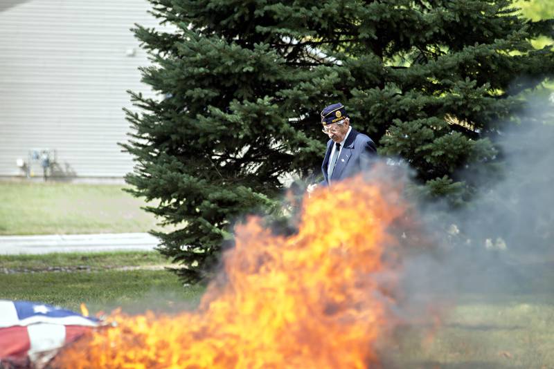 After a 21-gun volley, an honor guard member looks for brass in Kelly Park where the ceremony took place.