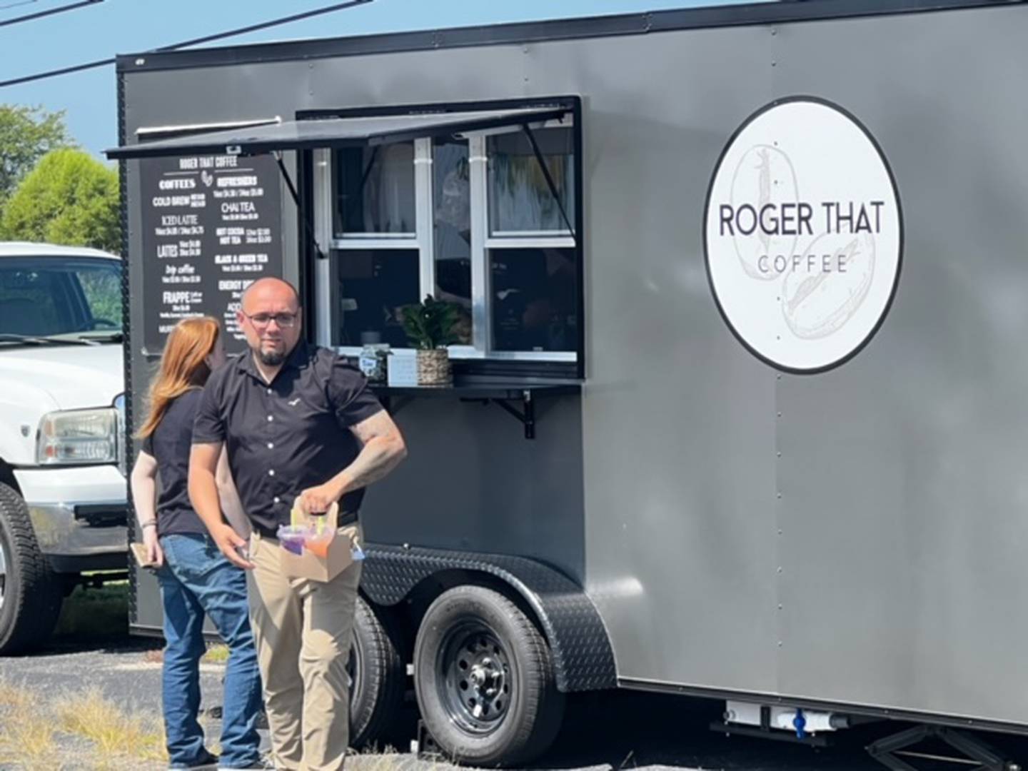 Robert Garcia of Sterling picks up his order from the new Roger That Coffee trailer in Sterling.