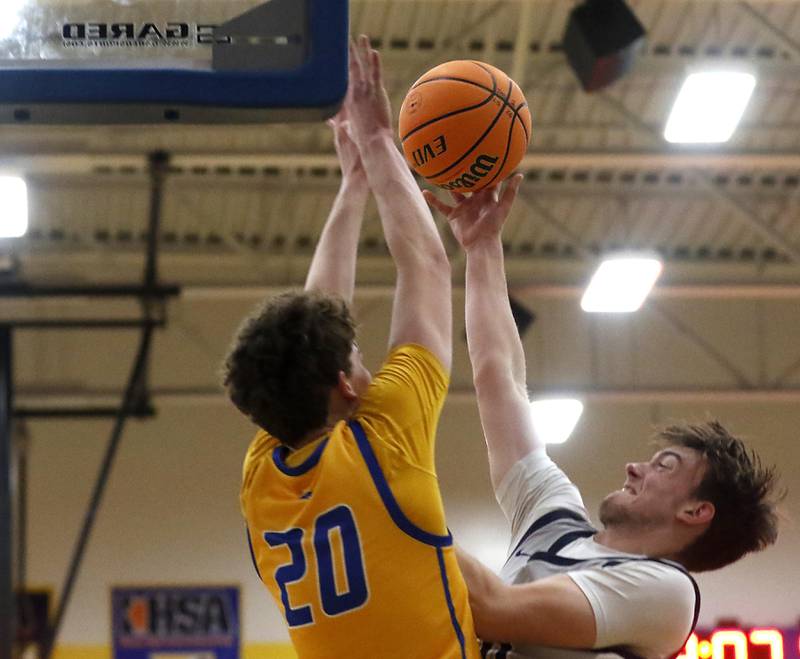 Cary-Grove's Brody Bays (right) shoots the ball over Johnsburg's Josh Kaunas during a Johnsburg Thanksgiving Tournament boys basketball game on Monday, Nov. 24, 2025, at Johnsburg High School.