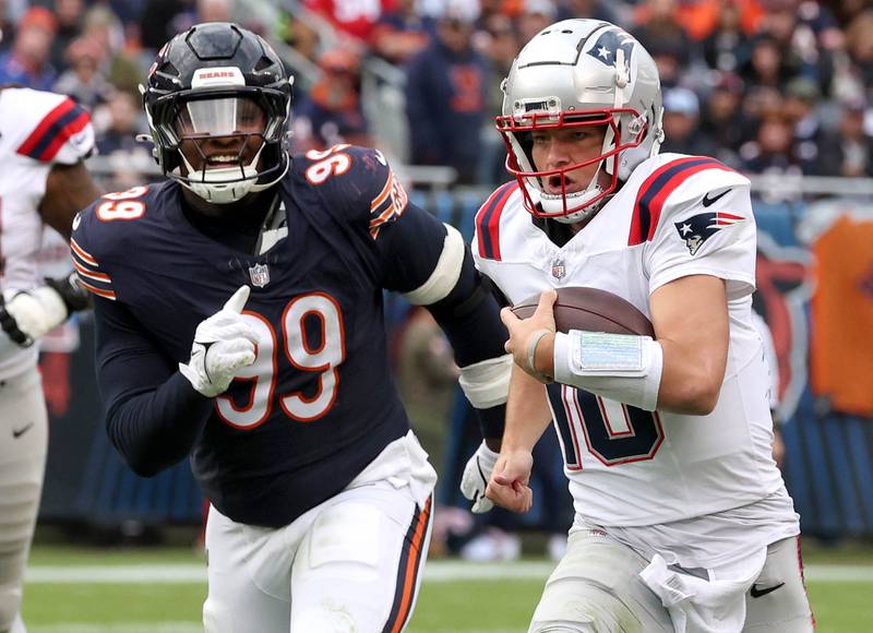 Chicago Bears defensive tackle Gervon Dexter Sr. pursues New England Patriots quarterback Drake Maye as he scrambles for yardage during their game Sunday, Nov. 10, 2024, at Soldier Field in Chicago.