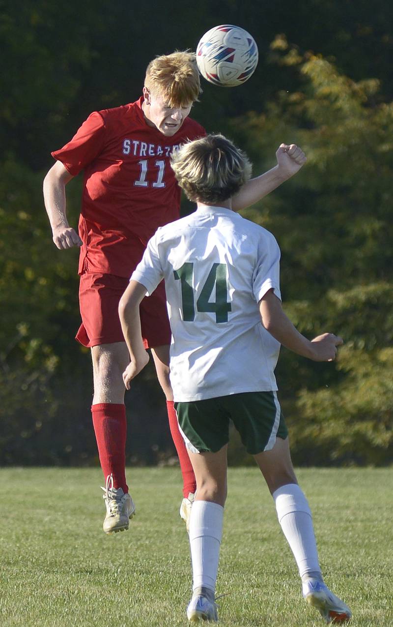 Streator’s Connor Decker gets a header past Coal City’s Creed Macaluso Coal City’s Carsen Hart in the first half of Tuesday's Illinois Central Eight Conference match at the James Street Recreation Center in Streator.