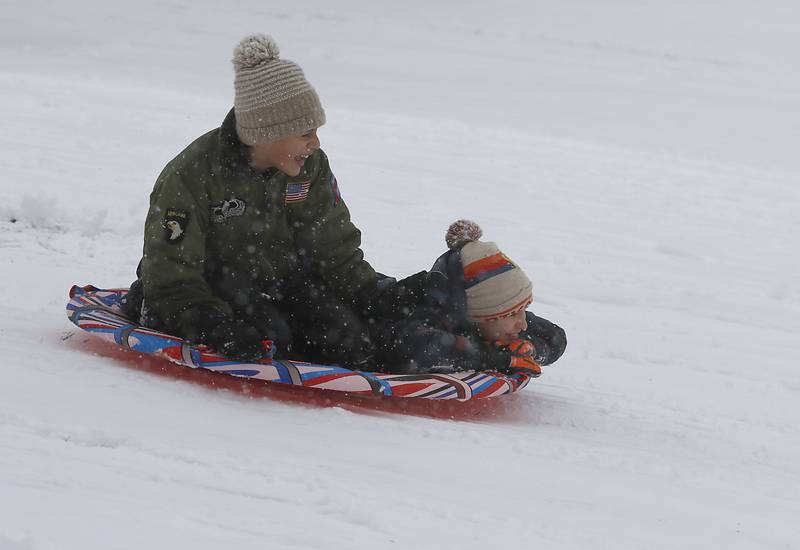 Anthony Domingo, 11, of Cary, and Henry Tuttle, 9, of Port Barrington, fly down a hill Wednesday, Jan. 25, 2023, while sledding with other children at Veteran Acres Park in Crystal Lake. Snow fell throughout the morning, leaving a fresh blanket of snow in McHenry County.