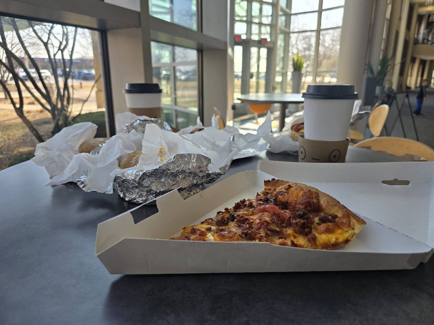 Coffee and a slice of breakfast pizza, are seen at the recently opened Cup of Joe by Cemeno's, located inside the Inwood Recreation Center at 3000 W. Jefferson St. in Joliet, and near Cemeno's Pizza At the Park, is seen on Sunday, Feb. 15, 2026.