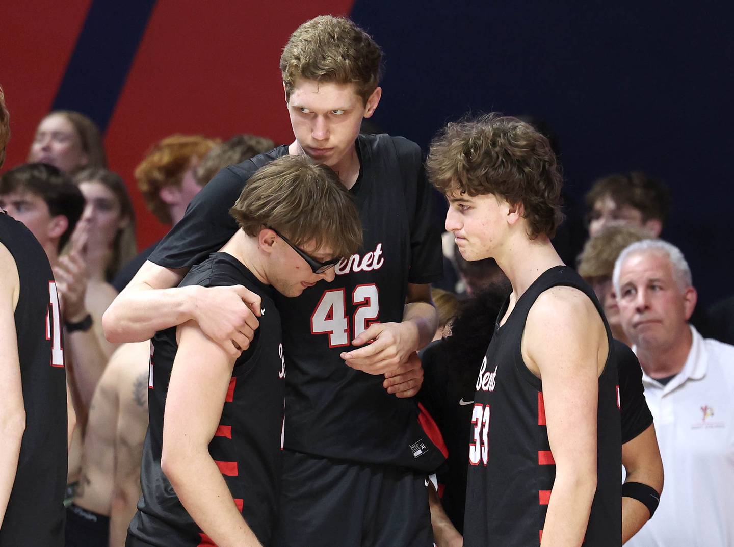 Benet players console each other as time ticks away Saturday, March 14, 2026, in their IHSA Class 4A state championship loss to Marist in the State Farm Center at the University of Illinois in Champaign.