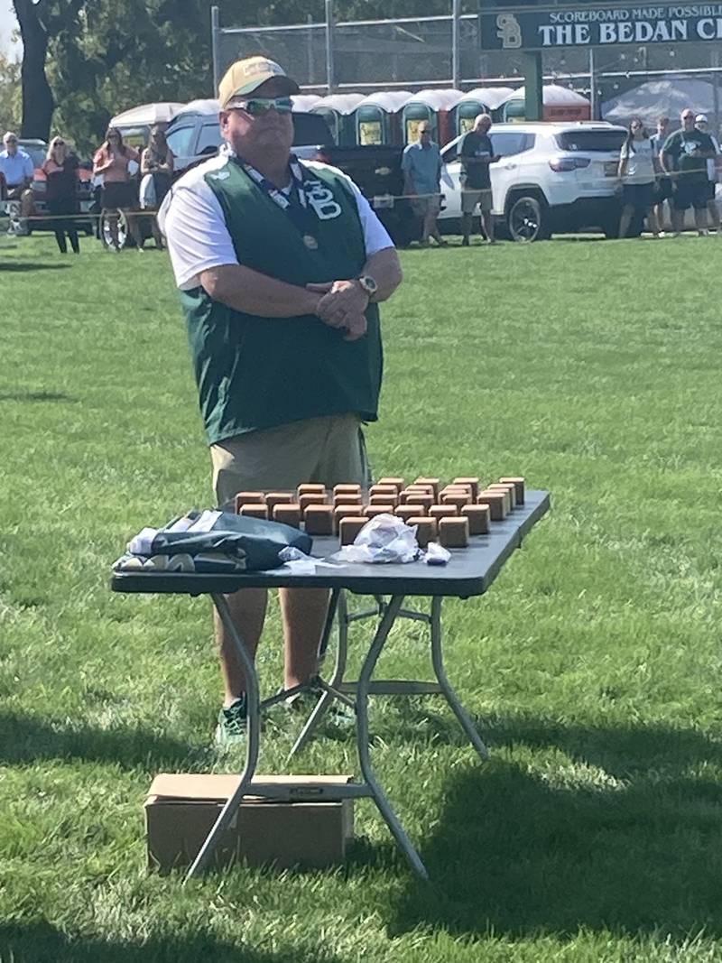 St. Bede coach Shawn Sons watches over the state championship ring ceremony for the Bruins softball team Saturday.