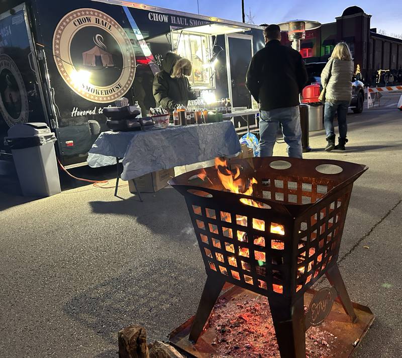 Chowhaul Smokehouse was one of the food vendors that braved the winter weather to serve visitors on Candy Cane Lane during Oregon's Candlelight Walk on Saturday, Nov. 30, 2024. The wood for the Etnyre fire pits was provided by Hands on Oregon.
