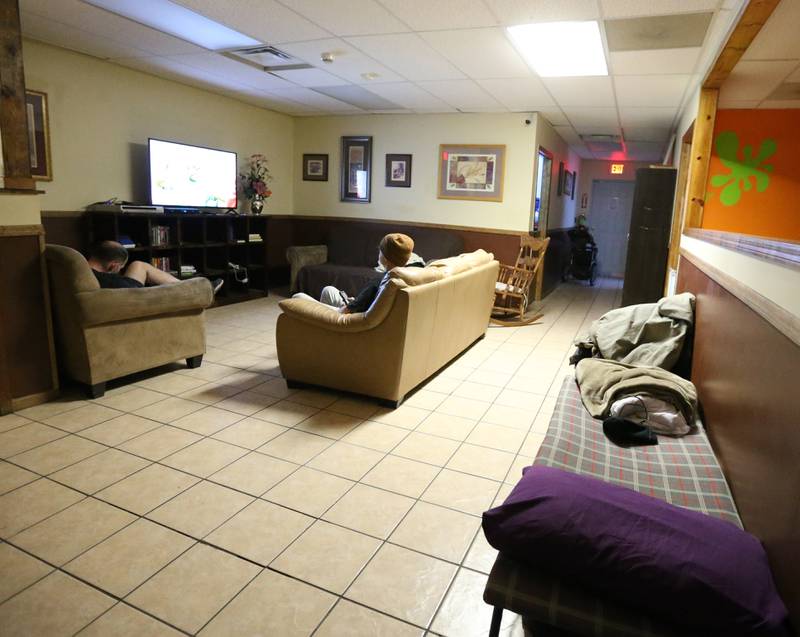 A view of the client lounge area at the Illinois Valley Public Action To Deliver Shelter (PADS) on Wednesday, Feb. 1, 2023 in Ottawa. Cots can be found in different rooms to meet the need for more space as beds are full. The newly proposed plan will include demolishing the current facility and building a new shelter on the same land.