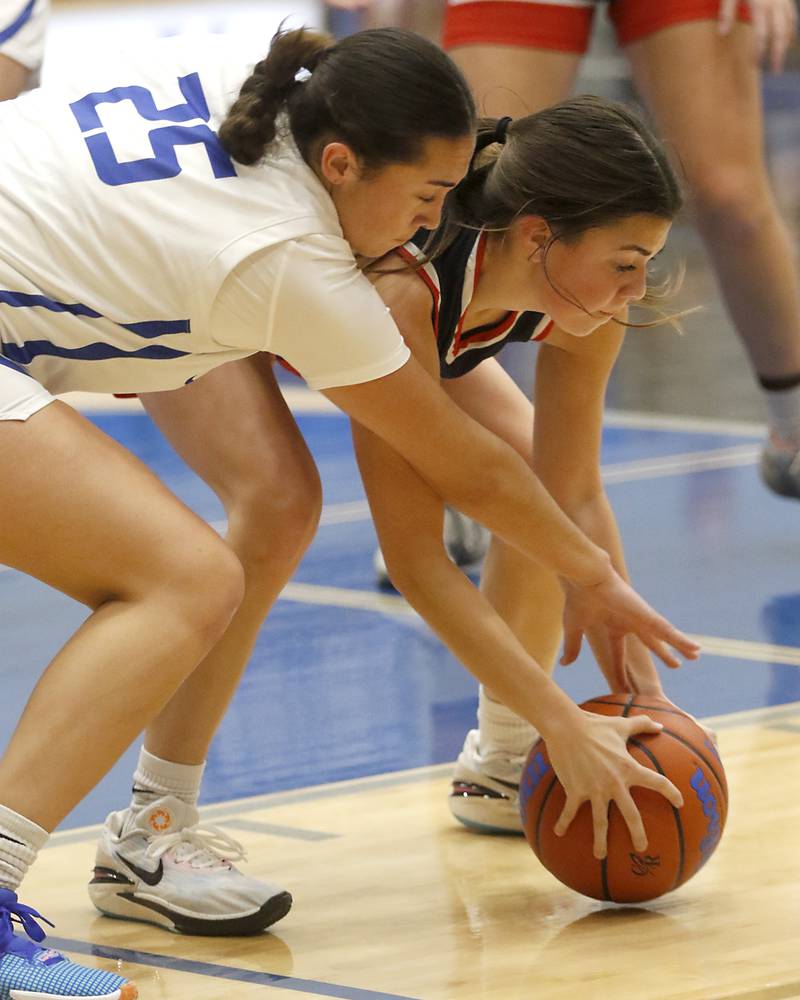 Burlington Central's Mia Hansen battles with Belvidere North's Ava Armstrong for a loose ball on Monday, Nov. 13, 2023, during pool play girls basketball game in the Burlington Central Mark Einwich Tournament.
