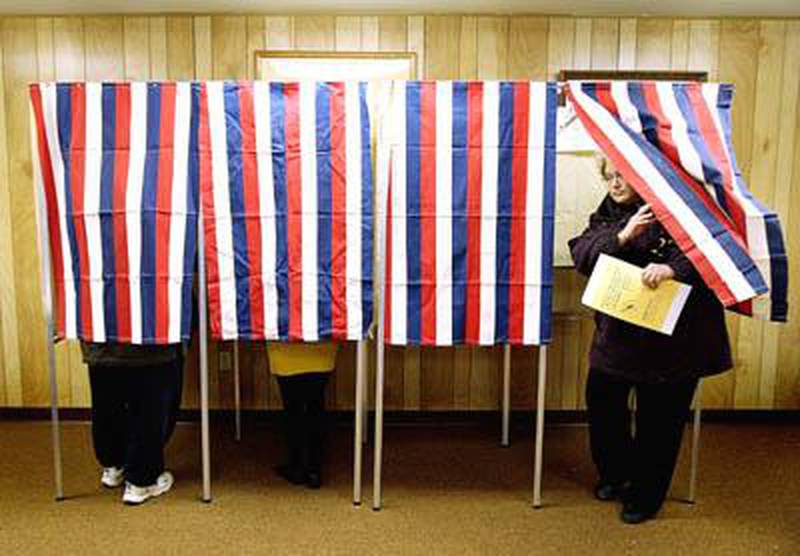 A Cortland resident leaves the booth after casting her vote Tuesday morning at the Cortland Township Building on South Prairie Street. Two Cortland precincts saw more than 200 voters by 8:30 a.m. Tuesday. Chronicle photo KATE WEBER