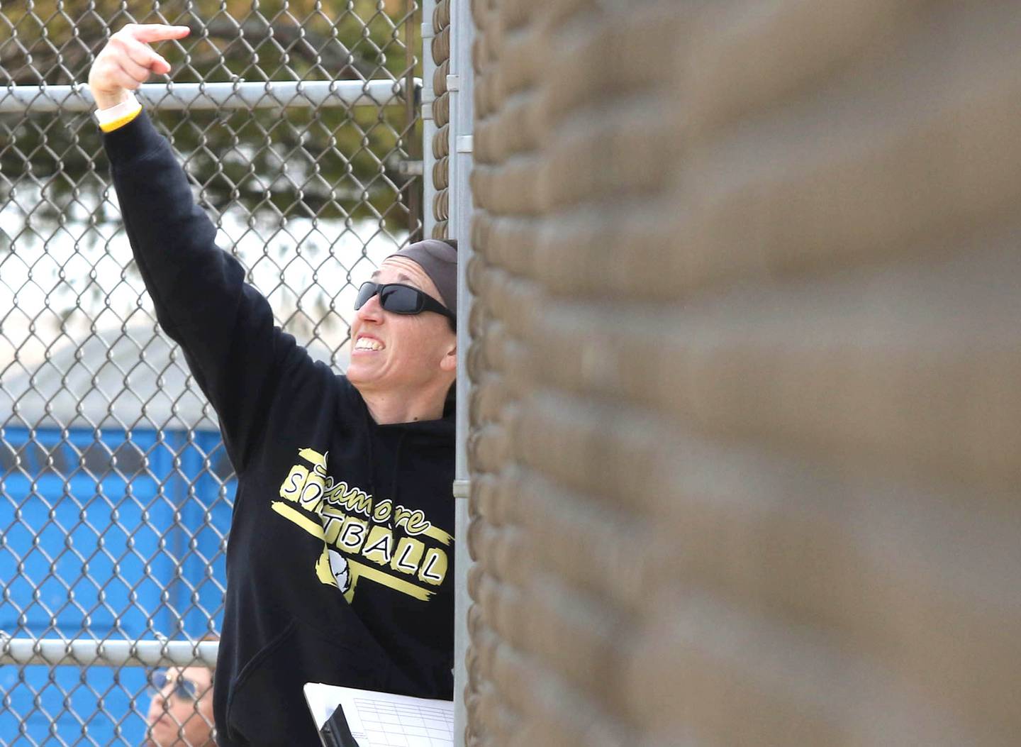 Jill Carpenter, Sycamore head coach, adjusts her outfileld during their game Wednesday against Harlem at Sycamore High school.