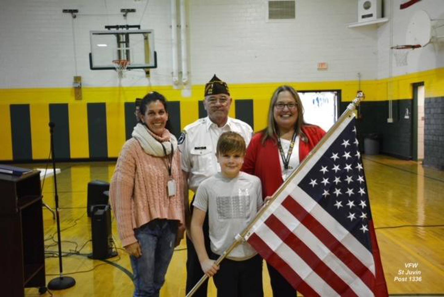 from left, 4th grade teacher Jenn Ness, Post Commander James “Hoppy” Phillips, Drake Heath and Principal Tracy Carlson