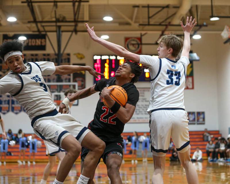 Yorkville's Braydon Porter (22) gets called for a charge on a drive to the basket during their Class 4A Naperville North Regional final basketball game between Yorkville at Downers Grove South, Feb 27, 2026 in Naperville.