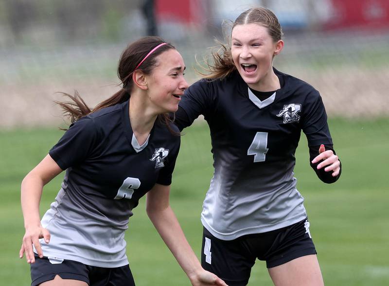 Kaneland's Taylor Mills (left) celebrates after scoring a goal against Sycamore with teammate Olivia Davis Wednesday, April 30, 2025, during their game at Kaneland High School in Maple Park.