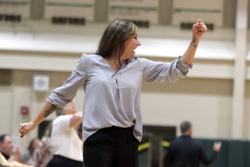 Prairie Ridge’s Head Coach Hilary Agnello celebrates as the Wolves win over Woodstock North in IHSA Class 3A Sectional semifinal volleyball action on Tuesday, Nov. 5, 2024, at  Crystal Lake South High School  in Crystal Lake.