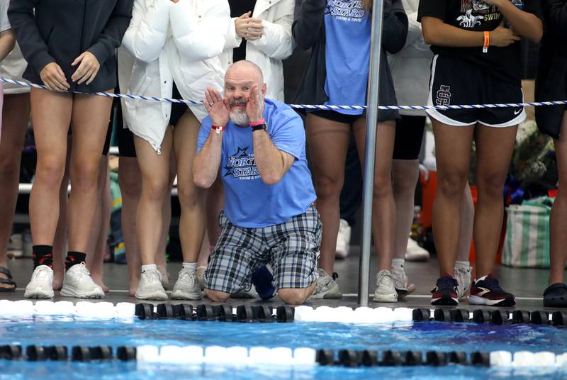St. Charles North Head Coach Rob Rooney yells to his athletes during the 200-yard individual medley championship heat during the IHSA Girls State Championships on Saturday, Nov. 16, 2024 at FMC Natatorium in Westmont.