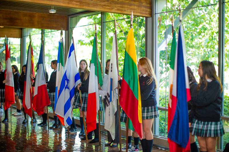Flag bearers prepare to process into Woodlands Academy’s chapel as part of the school’s Flag Ceremony on Sept. 13. The 21 flags this year represent nations where a Woodlands student or adult community member was born or holds dual citizenship.
