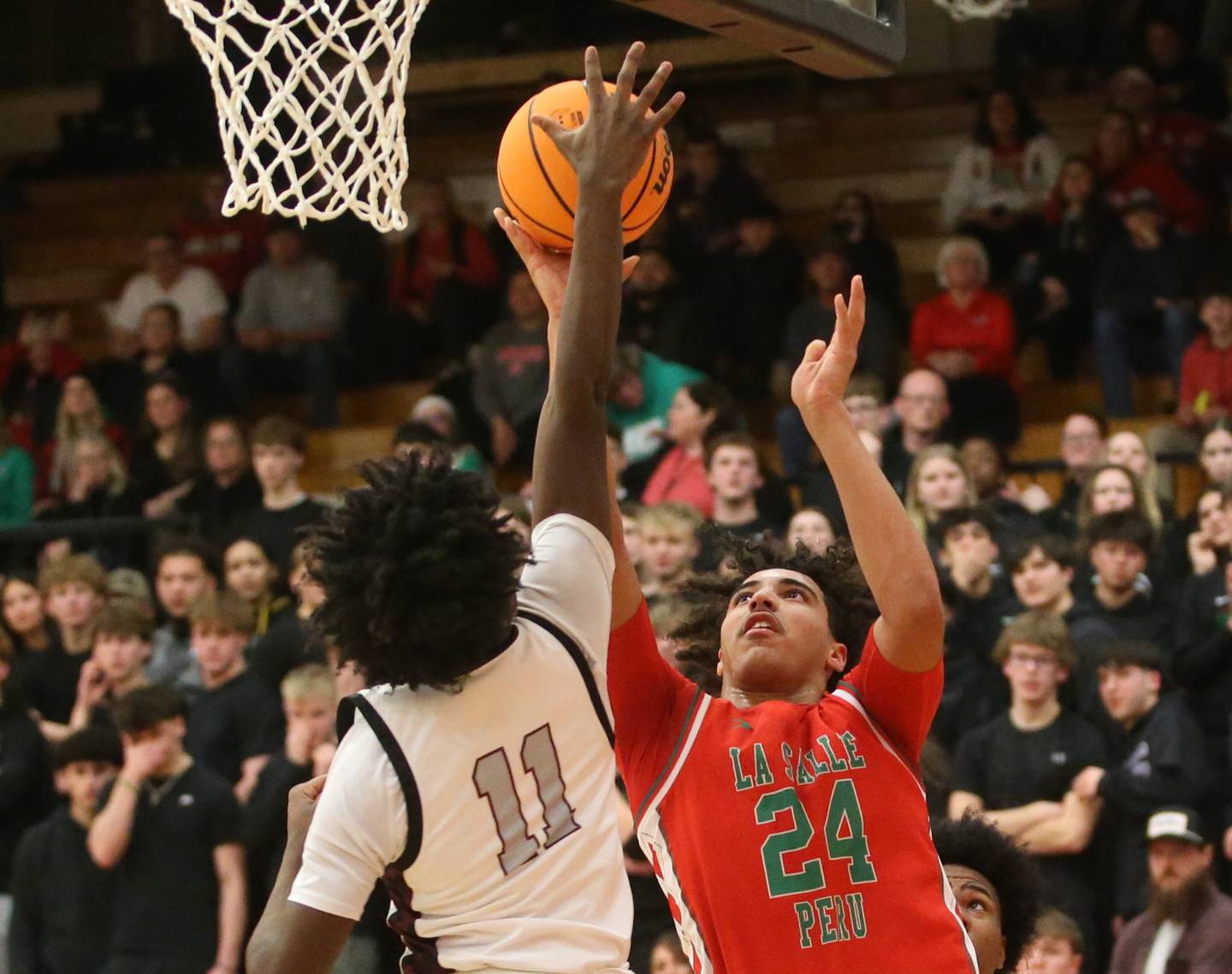 L-P's Marion Persich has his shot blocked by Peoria's Cameron Gunn during the Class 3A Sectional semifinal game on Wednesday, March 5, 2025 at Washington High School.